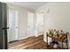 Hallway with hardwood-style floors, white doors, and a rolling bar cart, creating an inviting atmosphere at 6354 Old Pineville Rd # F, Charlotte, NC 28217