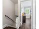 Hallway leads to bedroom with an office space, featuring natural light from a large window at 6354 Old Pineville Rd # F, Charlotte, NC 28217