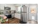 Bright kitchen featuring stainless steel appliances, white cabinets, and granite countertops at 6354 Old Pineville Rd # F, Charlotte, NC 28217