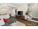 Comfortable living area featuring stylish flooring, a TV, and staircase access at 6354 Old Pineville Rd # F, Charlotte, NC 28217
