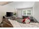 Comfortable living area featuring stylish flooring, a TV, and natural light from the window at 6354 Old Pineville Rd # F, Charlotte, NC 28217