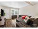 Bright living room featuring luxury floors, comfortable seating, and natural light from the windows at 6354 Old Pineville Rd # F, Charlotte, NC 28217