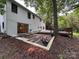 Spacious backyard with a brick patio, wooden deck and lush landscaping, great for outdoor entertaining and relaxation at 6614 Old Providence Rd, Charlotte, NC 28226