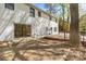 Spacious backyard featuring a brick patio, white-brick home, and a wooden deck for outdoor enjoyment at 6614 Old Providence Rd, Charlotte, NC 28226