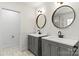 Modern bathroom with dual vanities, round mirrors, and marble-look tile floors at 6614 Old Providence Rd, Charlotte, NC 28226