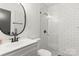 Updated bathroom features a modern vanity and a beautifully tiled shower at 6614 Old Providence Rd, Charlotte, NC 28226