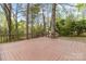 Expansive wooden deck surrounded by lush trees, ideal for outdoor living at 6614 Old Providence Rd, Charlotte, NC 28226
