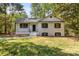 Charming renovated home featuring a classic white painted brick exterior with dark window shutters at 6614 Old Providence Rd, Charlotte, NC 28226