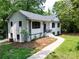 Charming white brick home with a landscaped front yard and walkway to the front porch at 6614 Old Providence Rd, Charlotte, NC 28226