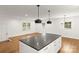 Open kitchen and dining area with white cabinets and modern light fixtures at 6614 Old Providence Rd, Charlotte, NC 28226