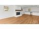 Bright living room with fireplace, built in cabinets, and luxury vinyl plank flooring at 6614 Old Providence Rd, Charlotte, NC 28226