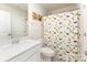 Bathroom featuring a white vanity, matching toilet, and a shower with a colorful dinosaur curtain at 7394 Echoing Hills Ln, Maiden, NC 28650