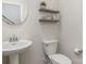 Charming powder room features a pedestal sink, decorative shelves, and a modern toilet at 7394 Echoing Hills Ln, Maiden, NC 28650