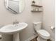 Powder room featuring a pedestal sink, toilet, and stylish decor on the walls at 7394 Echoing Hills Ln, Maiden, NC 28650