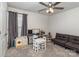 Bright, carpeted bedroom featuring a ceiling fan and furnished with toys and a gray futon at 7394 Echoing Hills Ln, Maiden, NC 28650