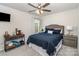 Cozy bedroom featuring a queen bed with a blue quilt, side tables and neutral gray walls at 7394 Echoing Hills Ln, Maiden, NC 28650