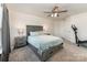 Spacious bedroom featuring a ceiling fan, carpet, and a gray bed frame at 7394 Echoing Hills Ln, Maiden, NC 28650