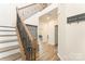 Inviting foyer with wood floors, a staircase, and a convenient hall tree at 7394 Echoing Hills Ln, Maiden, NC 28650