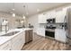 Bright kitchen featuring white cabinets, stainless steel appliances, and a center island with a sink at 7394 Echoing Hills Ln, Maiden, NC 28650