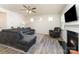 Cozy living room featuring a comfortable sectional sofa, hardwood floors, and a fireplace at 7394 Echoing Hills Ln, Maiden, NC 28650