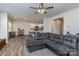 Open living area with hardwood floors, a comfortable sectional sofa, and a view into the kitchen at 7394 Echoing Hills Ln, Maiden, NC 28650