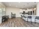 Spacious living area featuring hardwood floors, ample natural light, and kitchen with stainless steel appliances at 7394 Echoing Hills Ln, Maiden, NC 28650