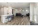 Open-concept home with kitchen island, hardwood floors, and a comfortable living room with natural light at 7394 Echoing Hills Ln, Maiden, NC 28650