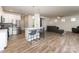 Open concept living space with island seating between a modern kitchen and an inviting living room at 7394 Echoing Hills Ln, Maiden, NC 28650