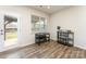 Sunlit room with hardwood floors, a back door, and views of the backyard at 7394 Echoing Hills Ln, Maiden, NC 28650