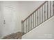 Staircase showcasing modern railing, white risers, and wood-look flooring at 7394 Echoing Hills Ln, Maiden, NC 28650