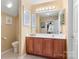 Bathroom with large mirror, wooden cabinets and standard toilet at 744 Ledgestone Ct, Tega Cay, SC 29708