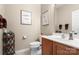 Bathroom featuring vanity with framed artwork and a decorative shelf at 744 Ledgestone Ct, Tega Cay, SC 29708