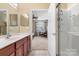 Bathroom featuring a cherry vanity and access to an ensuite bedroom with sitting area at 744 Ledgestone Ct, Tega Cay, SC 29708
