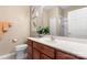 Bathroom featuring a cherry vanity, spacious countertop, and a large mirror at 744 Ledgestone Ct, Tega Cay, SC 29708