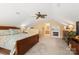 Comfortable carpeted bedroom with ceiling fan, fireplace and floral comforter at 744 Ledgestone Ct, Tega Cay, SC 29708
