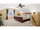 Bright bedroom with sitting area and ceiling fan, with a private stairwell at 744 Ledgestone Ct, Tega Cay, SC 29708