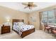 Bright bedroom with ceiling fan, sitting area, and a nautical-themed duvet cover at 744 Ledgestone Ct, Tega Cay, SC 29708