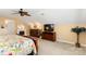 Comfortable carpeted bedroom with ceiling fan, TV, fireplace and floral comforter at 744 Ledgestone Ct, Tega Cay, SC 29708