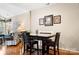 Cozy dining area with wood floors features a table with seating and artwork, creating a warm and inviting atmosphere at 744 Ledgestone Ct, Tega Cay, SC 29708