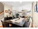 Open dining area with wood floors flows into the living room with abundant natural light, perfect for gatherings at 744 Ledgestone Ct, Tega Cay, SC 29708