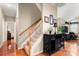 Inviting entryway with wood floors, stairs to upper level, and charming accent console table, creating a warm welcome to the home at 744 Ledgestone Ct, Tega Cay, SC 29708