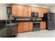 Spacious kitchen featuring stainless steel appliances, wood cabinets, and granite countertops at 744 Ledgestone Ct, Tega Cay, SC 29708