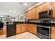 Well-equipped kitchen features wood cabinets, granite countertops, and stainless steel appliances at 744 Ledgestone Ct, Tega Cay, SC 29708
