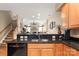 Kitchen area with bar and view into Gathering room with fireplace and plenty of natural light at 744 Ledgestone Ct, Tega Cay, SC 29708