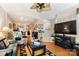 Spacious living room that flows into kitchen, complete with hardwood floors and a ceiling fan at 744 Ledgestone Ct, Tega Cay, SC 29708
