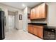 Extended pantry area features wood cabinetry and tile floors, adding to the functionality of the kitchen at 744 Ledgestone Ct, Tega Cay, SC 29708