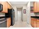 Functional pantry hallway with tile floor and ample cabinet space, providing practical storage solutions at 744 Ledgestone Ct, Tega Cay, SC 29708
