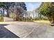 Expansive backyard featuring a shed and large paved area, perfect for outdoor activities at 7816 Wallace Ln, Charlotte, NC 28212