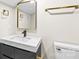 Modern bathroom with a square mirror, sleek fixtures, and a white countertop at 7816 Wallace Ln, Charlotte, NC 28212