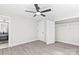 A spacious bedroom with hardwood floors, a ceiling fan, and a modern closet at 7816 Wallace Ln, Charlotte, NC 28212